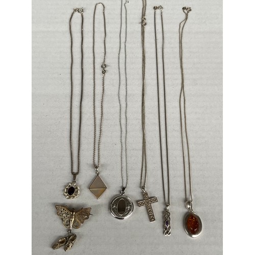 43 - 6 Silver chains and silver pendants together with silver brooch. Includes locket pendant and garnet ... 