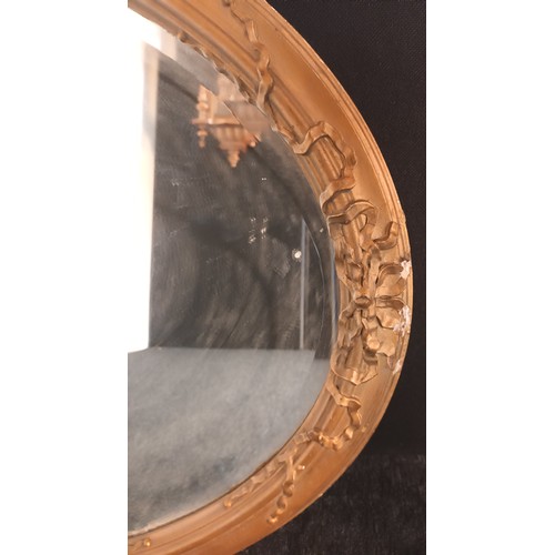 772 - Antique oval mirror presented within a moulded gilt frame