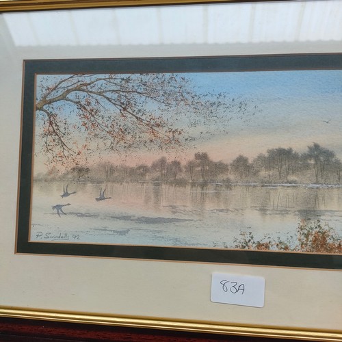 83a - Water colour depicting birds flying over lake signed P . Swindells .