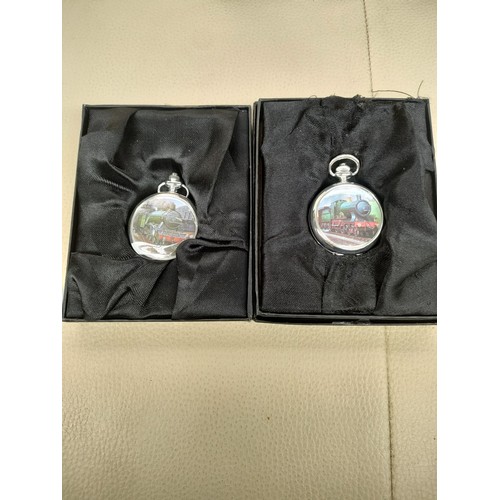 89A - 2 train themed pocket watches .