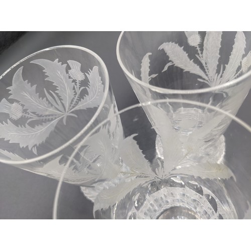 562 - Six Edinburgh crystal thistle cut champagne flutes together with ten thistle cut wine glasses