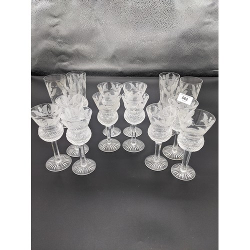 562 - Six Edinburgh crystal thistle cut champagne flutes together with ten thistle cut wine glasses