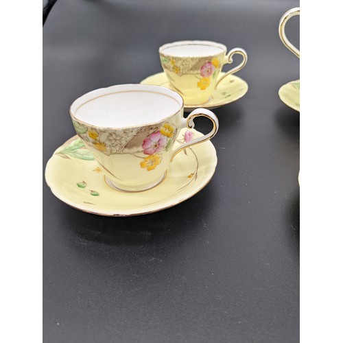 718 - Twelve piece Aynsley bone china tea set in a yellow floral design