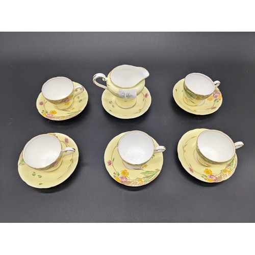 718 - Twelve piece Aynsley bone china tea set in a yellow floral design