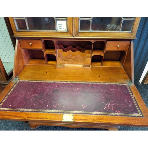 770a - 19th century bureau [W.J. Mansell] the moulded cornice above two glass doors with moulded design, le... 