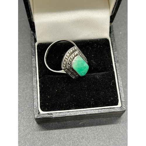 512 - 935 silver art deco ring set with a Jade centre stone off set by marcasite cluster. [Ring size N] [W... 