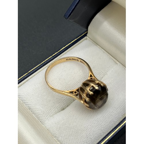 517 - 9ct gold ladies ring set with a large brown quartz stone. [Ring size O] [3.53Grams]