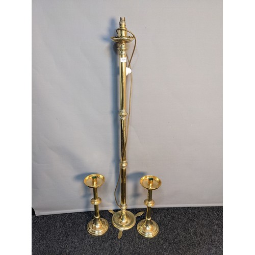 879 - Antique brass floor lamp, together with two brass candlesticks