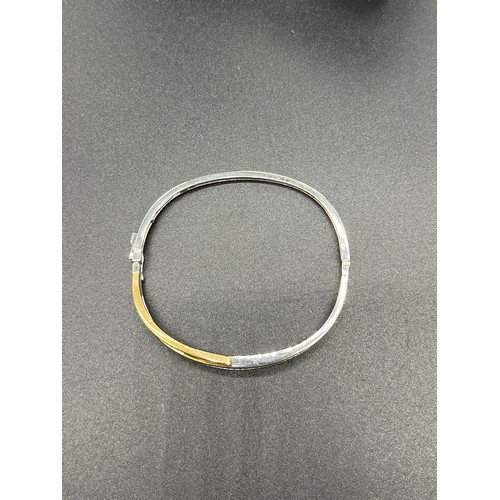 535 - 9ct white and yellow gold bangle set with diamonds. 0.40cts. [12.92grams] [Will post]