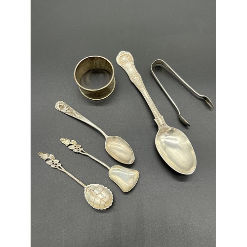 548 - Collection of silver marked flatwares includes Chinese silver tea spoon and napkin ring. [134grams]