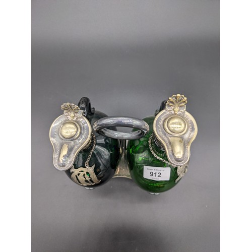 912 - Pair of antique green glass decanters with plated collar and stoppers, within a plated caddy [28cm]