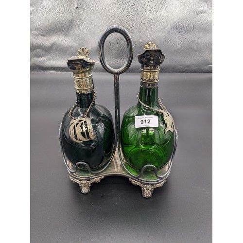 912 - Pair of antique green glass decanters with plated collar and stoppers, within a plated caddy [28cm]