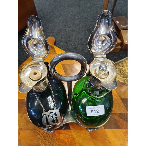 912 - Pair of antique green glass decanters with plated collar and stoppers, within a plated caddy [28cm]