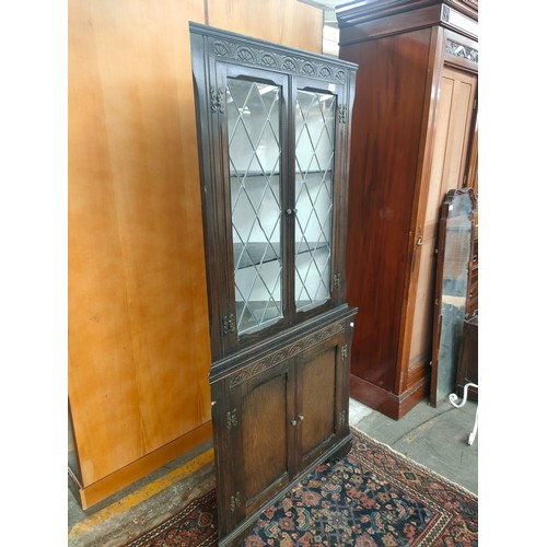 165 - Old charm style oak corner cabinet. Needs replacement glass.