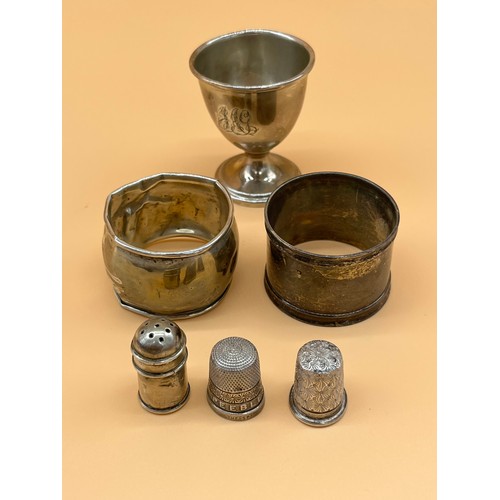 27 - Various silver to include two napkin rings, Egg cup, small pepper pot and two silver thimbles to inc... 