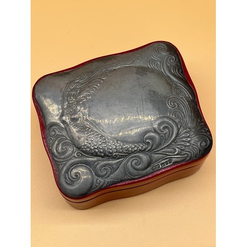 121 - London silver lidded jewel box, red leather base, Silver top depicts nude mermaid. [5x9.5x8cm] [Will... 