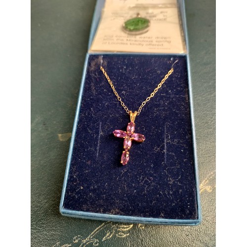49a - 9ct gold chain set with 9ct gold cross with purple stones together with Lourdes France medal .