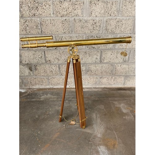 266a - Large brass telescope on wooden support stand .