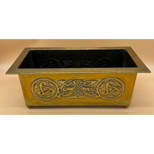 27 - Arts and Crafts brass worked planter. detailed with Celtic panels. [Missing handle] [19x49x24cm]