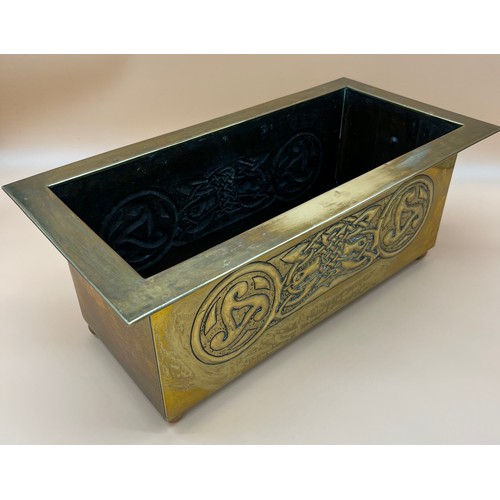 27 - Arts and Crafts brass worked planter. detailed with Celtic panels. [Missing handle] [19x49x24cm]