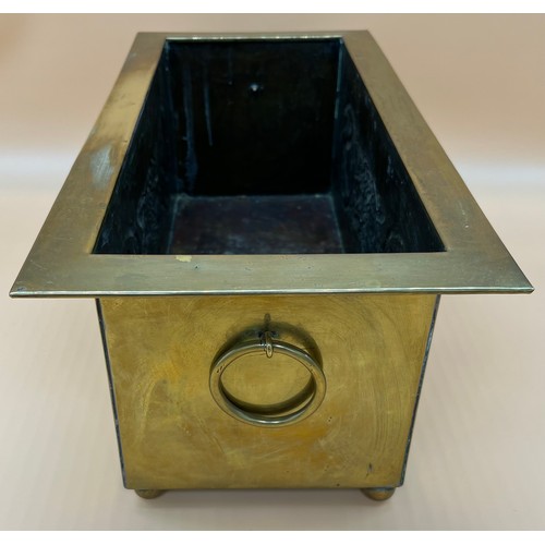 27 - Arts and Crafts brass worked planter. detailed with Celtic panels. [Missing handle] [19x49x24cm]