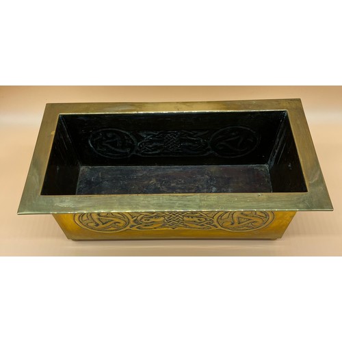 27 - Arts and Crafts brass worked planter. detailed with Celtic panels. [Missing handle] [19x49x24cm]