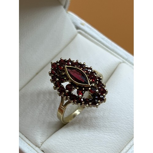 52 - 14ct yellow gold ladies ring set with a cluster of garnet stones set with a large garnet to the cent... 