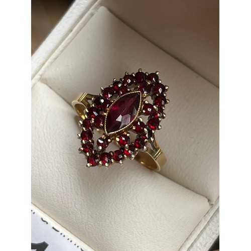 53 - 14ct yellow gold ladies ring set with a cluster of garnet stones set with a large garnet to the cent... 