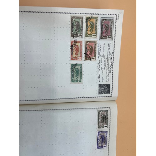 63 - The Triumph stamp album containing a large quantity of stamps from around the world. [Will post]