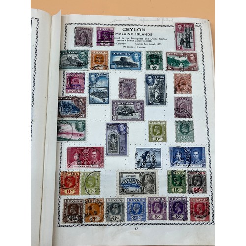 63 - The Triumph stamp album containing a large quantity of stamps from around the world. [Will post]