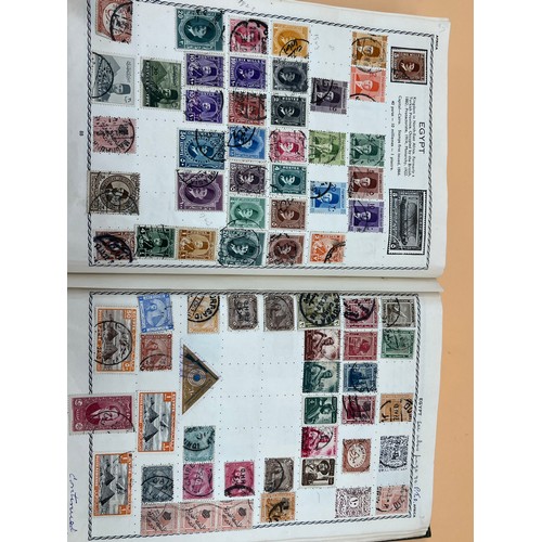 63 - The Triumph stamp album containing a large quantity of stamps from around the world. [Will post]