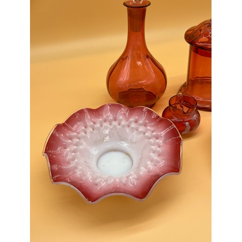 175 - Five various cranberry glass items to include decanter, lidded pot, Mary Gregory small jug and scall... 