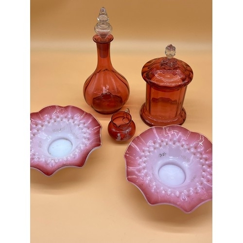 175 - Five various cranberry glass items to include decanter, lidded pot, Mary Gregory small jug and scall... 