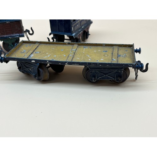 38 - Four antique Bing tin plate train wagons and carriage.