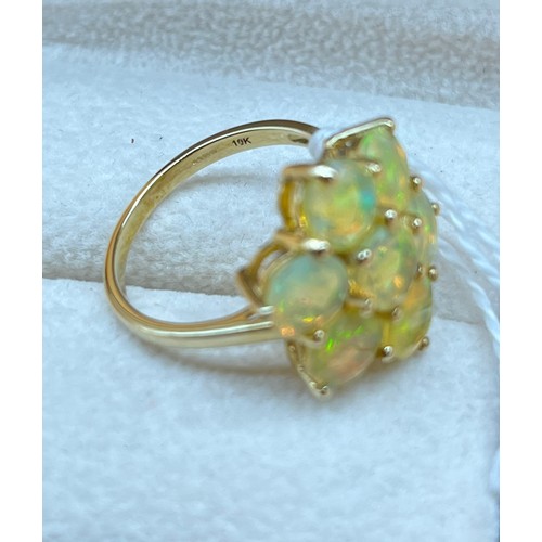 11A - 10ct yellow gold ladies ring set with 7 opalescent style stones. [Ring size P] [3.86gram]