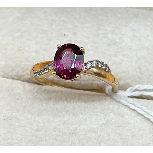 19A - 10ct yellow gold ladies ring set with a single pink tourmaline stone off set by white spinel stones.... 