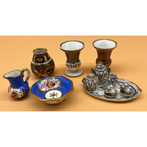 23A - Collection of collectable miniature porcelain items to include Dolls tea for two service, Urn vases,... 