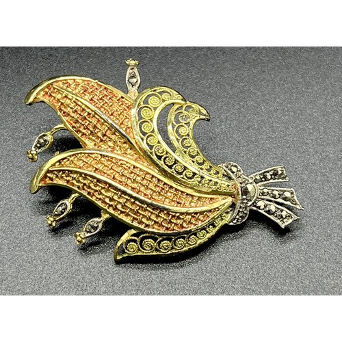 503 - 14ct yellow gold ornate brooch designed with marcasite stones. [6.02grams]