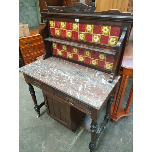 300 - Victorian Wash stand, the art nouveau themed tile back with open shelf above a marble surface, two d... 