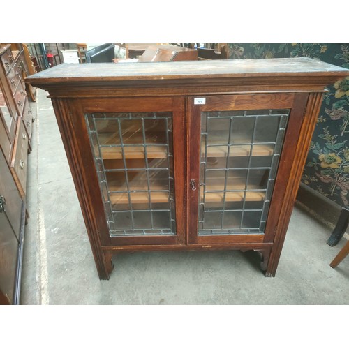 291 - 19th century oak display cabinet with leaded glass .