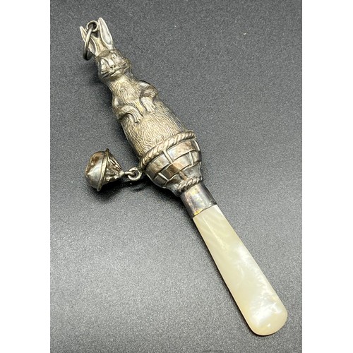 30 - Birmingham silver and mother of pearl handle baby rattle. Silver is formed in the shape of a rabbit ... 