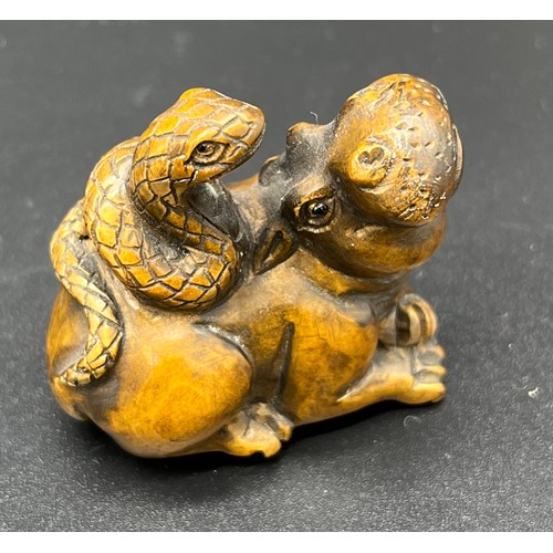 49 - Hand carved Japanese Netsuke sculpture of a hippo resting with a snake on its back. Signed and fitte... 