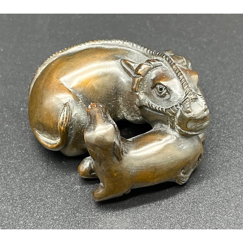 50 - Hand carved Japanese Netsuke sculpture of a An Ox and foal. Signed [4cm in length]