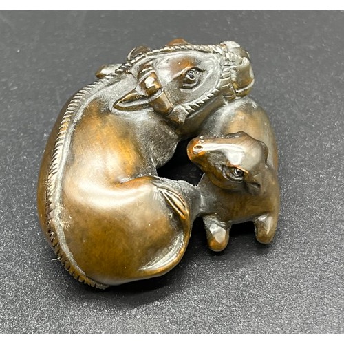 50 - Hand carved Japanese Netsuke sculpture of a An Ox and foal. Signed [4cm in length]