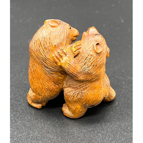 52 - Hand carved Japanese Netsuke sculpture of two bears fighting. Signed. [4.4cm high]