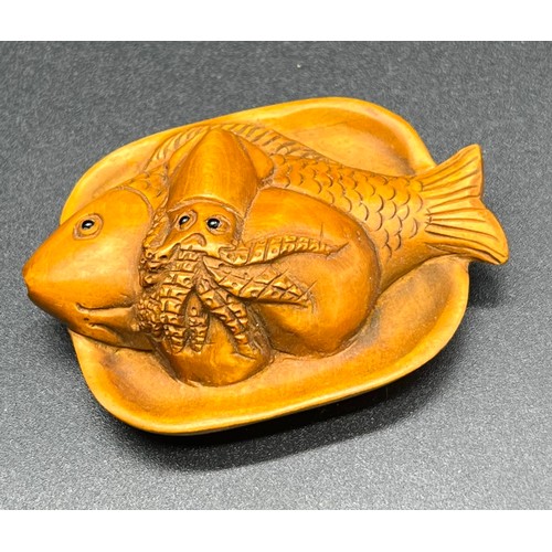 56 - Hand carved Japanese Netsuke sculpture of a sea food platter. Signed. [5.4cm in length]