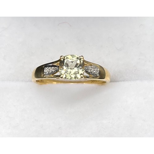 59 - 10ct yellow gold ladies ring set with a single cushion cut pale green spinel ring off set by diamond... 