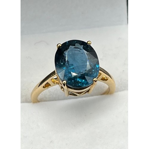 63 - 10ct yellow gold ring set with a large oval cut blue spinel stone. [Ring size P] [4.11Grams]