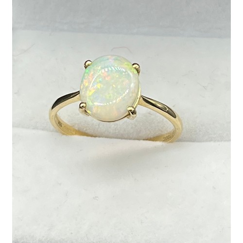 65 - 10ct yellow gold ladies ring set with a single oval cut opal stone. [Ring size S] [1.83Grams]