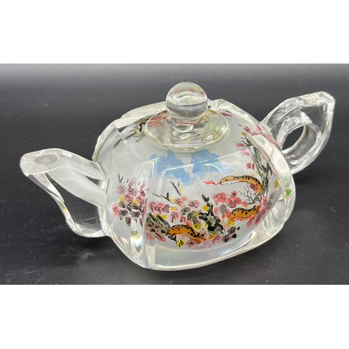 68 - A Chinese reverse painted glass teapot, depicting scenes of snakes. [6.5cm high x 14cm in length]